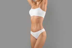 A cropped shot of a woman’s torso after a liposculpture procedure