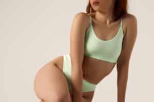 Fit woman in stylish lingerie showcasing a sculpted physique, highlighting the natural contouring benefits of fat transfer for body enhancement