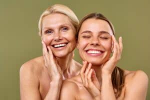 Young and mature women with smooth, glowing skin stand side by side, showcasing the results of facelift procedures and advanced skin care treatments